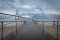 Long bridge over tagus river and pier in Lisbon at dawn Royalty Free Stock Photo