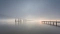 Long bridge over tagus river in Lisbon at sunrise with fog. Royalty Free Stock Photo