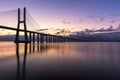 Vasco da Gama bridge at sunrise in Lisbon, Portugal. Vasco da Gama Bridge is a cable-stayed bridge flanked by viaducts and Royalty Free Stock Photo