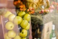 Vase with apples on beautiful background clouseup