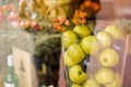 Vase with apples on beautiful background clouseup