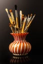 Vase with artistic brushes on the black background Royalty Free Stock Photo