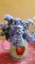 Vase with beaitiful wild purple flowers