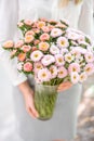 Vase with beautiful aster flower bouquet in womens hand. vase with summer flowers at nature background