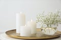 Vase with beautiful flowers and burning candles on table indoors Royalty Free Stock Photo