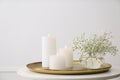 Vase with beautiful flowers and burning candles on table indoors. Interior elements Royalty Free Stock Photo