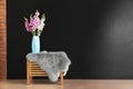 Vase with beautiful gladiolus flowers on table near dark wall indoors Royalty Free Stock Photo