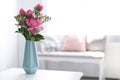 Vase with beautiful peony flowers on table