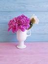 Vase of a beautiful peony holiday gentle soft on a colored anniversary wooden background fresh