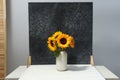 Vase with beautiful sunflowers and double-sided backdrop on table in photo studio Royalty Free Stock Photo