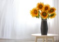 Vase with beautiful yellow sunflowers on table in room, space for text Royalty Free Stock Photo