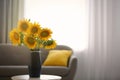 Vase with beautiful yellow sunflowers on table in room, space for text Royalty Free Stock Photo