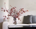 Vase of blossoms on table in modern living room Royalty Free Stock Photo