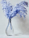 Vase of blue reeds on grunge gray background with copy space Royalty Free Stock Photo