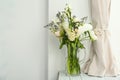Vase with bouquet of beautiful flowers on table Royalty Free Stock Photo