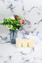 vase of bouquet of flowers and white candle, scent sensory. Home decoration and self pampering concept Royalty Free Stock Photo