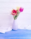 Vase bouquet of tulips decor arrangement home colorful romantic elegance on wooden background Royalty Free Stock Photo