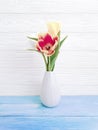 Vase bouquet of tulips decor interior springtime colorful romantic elegance on wooden background Royalty Free Stock Photo