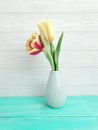 Vase bouquet of tulips decor springtime colorful romantic elegance on wooden background Royalty Free Stock Photo