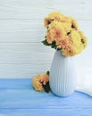 Vase bouquet vintage plant yellow chrysanthemum home elegance celebration on a wooden background, autumn blossom