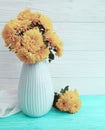 Vase bouquet yellow chrysanthemum home elegance celebration on a wooden background, autumn blossom