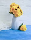 Vase bouquet vintage yellow chrysanthemum home elegance celebration on a wooden background, autumn blossom