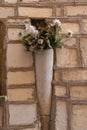 Vase on brick wall in pastel collors