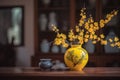 A vase filled with yellow Apricot blossom at the table. Lunar new year decoration