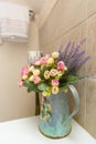 Vase with flovers in bathroom