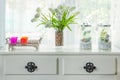 Vase with flower and vintage decorate on table with windowsill i