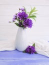 Vase flowers bouquet bell, purple textile table beauty decorative spring chrysanthemum arrangement on a wooden background Royalty Free Stock Photo