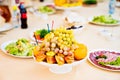 vase with fruit platter on the festive table. a delicious and healthy snack. Royalty Free Stock Photo