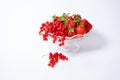 Vase on a long leg with fruit with strawberries and red currants and several berries on a white background Royalty Free Stock Photo