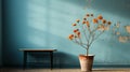 a vase with orange flowers in front of a blue wall Royalty Free Stock Photo