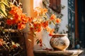 a vase with orange flowers sitting on a stone ledge Royalty Free Stock Photo