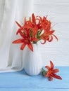 Vase orange lily retro holiday composition design on a wooden background textiles