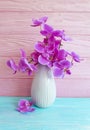 Vase orchid flower bouquet elegance arrangement on a wooden background