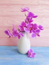 Vase orchid flower bouquet vintage decorate elegance arrangement on a wooden background Royalty Free Stock Photo