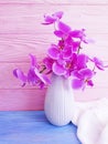 Vase orchid flower on wooden background