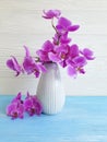 Vase orchid on a wooden background