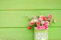 Vase with Plastic flowers and green wall Royalty Free Stock Photo