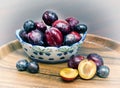 Vase with plums. wooden tray Royalty Free Stock Photo