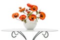 Vase with red poppies is on a coffee table, isolated on a white Royalty Free Stock Photo