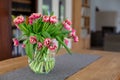 Vase with red tulips on a table in living room Royalty Free Stock Photo