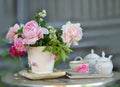 Vase of roses and tea tray