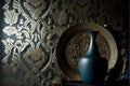 a vase sitting on a table next to a wallpapered wall with a gold design on it and a blue vase