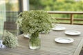 Vase on table. Dining table on veranda. Lunch in summer