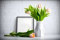 Vase of tulips flower on the table and empty photo frame mockup template Royalty Free Stock Photo