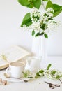 Vase with White Flowers Bird Cherry Tree, Morning, Cup with Coffee, Old Book Royalty Free Stock Photo