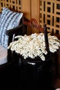 Vase with white flowers with hang bar near sofa in vintage asian Royalty Free Stock Photo